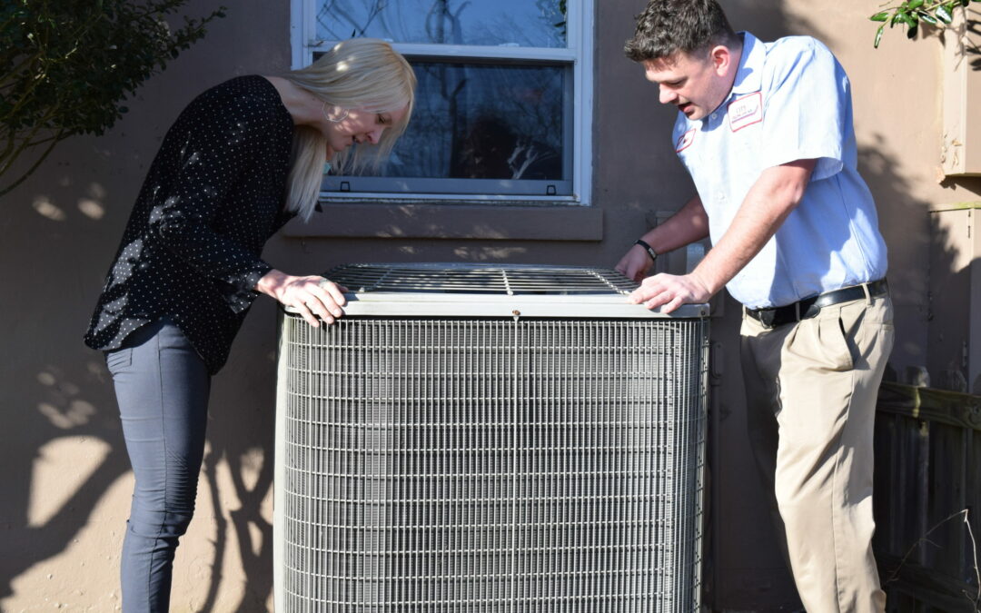 Client and City HVAC technician inspecting HVAC